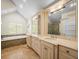 Elegant bathroom featuring double sinks, a luxurious soaking tub, and tasteful mosaic tile accents at 876 Ranch Rd, Tarpon Springs, FL 34688