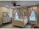 Charming bedroom with floral wallpaper, canopy bed, and soft pink accents for a cozy feel at 876 Ranch Rd, Tarpon Springs, FL 34688