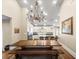 A dining room featuring a large wooden table with benches and a view into the kitchen at 876 Ranch Rd, Tarpon Springs, FL 34688
