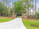 Gated entry, lined with trees, leads to the lovely home at 876 Ranch Rd, Tarpon Springs, FL 34688