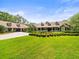 Beautiful one-story home with a manicured front lawn, long driveway and porte cochere at 876 Ranch Rd, Tarpon Springs, FL 34688