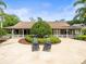 Charming home with a well-manicured front yard at 876 Ranch Rd, Tarpon Springs, FL 34688