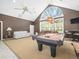 An open-concept game room featuring a billiard table, neutral carpet, and great lighting at 876 Ranch Rd, Tarpon Springs, FL 34688