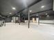 Large garage space with overhead lighting and ample room for storage or workshop activities at 876 Ranch Rd, Tarpon Springs, FL 34688