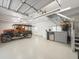 Bright garage space includes mini refrigerator, cabinets, stairs, and an antique truck at 876 Ranch Rd, Tarpon Springs, FL 34688
