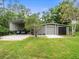 Spacious garage and additional covered parking provide ample room for vehicles and equipment at 876 Ranch Rd, Tarpon Springs, FL 34688