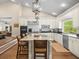 Modern kitchen with a center island, stainless steel appliances, and an open view to the dining area at 876 Ranch Rd, Tarpon Springs, FL 34688
