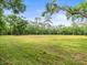 Expansive land provides a serene and private setting surrounded by mature trees at 876 Ranch Rd, Tarpon Springs, FL 34688