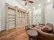 Cozy seating area with built-in shelving and hardwood floors at 876 Ranch Rd, Tarpon Springs, FL 34688