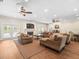 Spacious living room featuring a fireplace, hardwood floors, and comfortable furniture at 876 Ranch Rd, Tarpon Springs, FL 34688