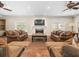 Spacious living room with a fireplace, ceiling fans, and lots of natural light at 876 Ranch Rd, Tarpon Springs, FL 34688