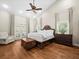 Main bedroom with wood floors, accent chest, and French doors at 876 Ranch Rd, Tarpon Springs, FL 34688