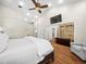 Bright and airy main bedroom with a seating area, ensuite and vaulted ceiling at 876 Ranch Rd, Tarpon Springs, FL 34688