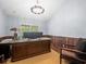 Office space with wainscoting, large desk, and ample natural light at 876 Ranch Rd, Tarpon Springs, FL 34688