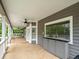 Large covered outdoor patio with bar and views of the backyard at 876 Ranch Rd, Tarpon Springs, FL 34688