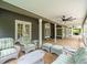 Covered patio featuring comfortable wicker seating and a ceiling fan at 876 Ranch Rd, Tarpon Springs, FL 34688