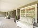 Inviting covered porch with seating, offering a relaxing outdoor space at 876 Ranch Rd, Tarpon Springs, FL 34688