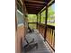 Inviting covered porch offers a relaxing outdoor seating area to enjoy the surrounding views at 876 Ranch Rd, Tarpon Springs, FL 34688