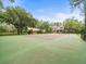 On-site tennis court for recreation, surrounded by lush landscaping and property amenities at 876 Ranch Rd, Tarpon Springs, FL 34688