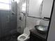 Modern bathroom showcasing tiled shower, glass door, and stylish vessel sink at 8822 Rocky Creek Dr, Tampa, FL 33615