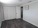 Bright bedroom featuring laminate floors, a closet, and natural light at 8822 Rocky Creek Dr, Tampa, FL 33615