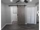 A bedroom features a sliding barn door to ensuite bathroom, and closet at 8822 Rocky Creek Dr, Tampa, FL 33615