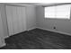 Comfortable bedroom with wood-look floors, white closet doors, and a bright window at 8822 Rocky Creek Dr, Tampa, FL 33615