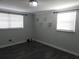 Serene bedroom features wood-look floors, two windows, and neutral decor at 8822 Rocky Creek Dr, Tampa, FL 33615