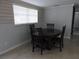 Cozy dining area with wood accent wall, a round table, and seating for four at 8822 Rocky Creek Dr, Tampa, FL 33615