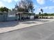 Charming home featuring a covered patio with chairs and an extended brick paved driveway, offering curb appeal and outdoor living at 8822 Rocky Creek Dr, Tampa, FL 33615