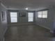 Inviting living room with tile floors, soft blue walls, and natural light from multiple windows at 8822 Rocky Creek Dr, Tampa, FL 33615
