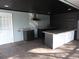 The outdoor kitchen has granite counters, stainless hood and black cabinets at 8822 Rocky Creek Dr, Tampa, FL 33615