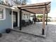 Close-up of the patio with a pergola and chairs, showcasing the outdoor living space and charming details at 8822 Rocky Creek Dr, Tampa, FL 33615