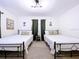 Bright bedroom with matching twin beds, stylish decor, and lots of natural light at 9948 51St N Ave, St Petersburg, FL 33708