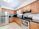 Well-equipped kitchen with stainless steel appliances, granite countertops, and ample cabinetry at 9948 51St N Ave, St Petersburg, FL 33708