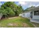 Lush backyard with grassy areas, mature trees, and a shed, offering a peaceful outdoor setting at 10275 117Th Dr, Largo, FL 33773