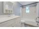 Clean bathroom with a classic white vanity, built-in shelves, and a shower-tub combo at 10275 117Th Dr, Largo, FL 33773