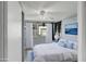 Comfortable bedroom featuring a ceiling fan, a window with curtains, and ample natural light at 10275 117Th Dr, Largo, FL 33773
