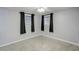Bright bedroom featuring neutral walls, carpeted flooring, and dual windows with stylish dark curtains at 10275 117Th Dr, Largo, FL 33773