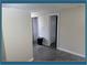 Hallway featuring neutral walls, white trim, and a dark gray floor at 10275 117Th Dr, Largo, FL 33773
