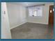 Bright living room featuring neutral walls, updated windows, and a dark gray floor at 10275 117Th Dr, Largo, FL 33773