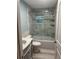Updated bathroom with blue walls, marble-tiled shower, and stylish vanity with sink at 11096 117Th Way, Seminole, FL 33778