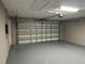 Clean garage features painted walls, epoxy floor, overhead door with opener at 11096 117Th Way, Seminole, FL 33778