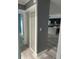 Neutral hallway leading to the kitchen with modern grey flooring at 11096 117Th Way, Seminole, FL 33778