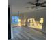 An empty, well-lit room featuring luxury vinyl flooring, neutral paint and modern fan at 11096 117Th Way, Seminole, FL 33778