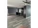 Spacious living room featuring vinyl floors, open concept kitchen, and neutral paint at 11096 117Th Way, Seminole, FL 33778