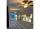 Bright living room with modern ceiling fan and stylish lighting fixture above the window at 11096 117Th Way, Seminole, FL 33778