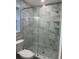 Modern shower with glass doors and marble tiled surround at 11096 117Th Way, Seminole, FL 33778