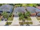Aerial view of home with palm trees, landscaping and a two-car garage in a residential neighborhood at 11142 Spring Point Cir, Riverview, FL 33579