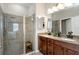 Bathroom with dual granite vanity, shower, and glass door, creating a relaxing space at 11142 Spring Point Cir, Riverview, FL 33579
